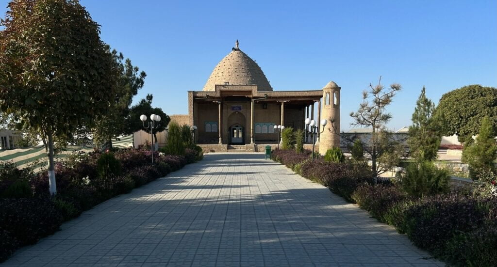 the Kyk-Ota Mosque in Bishkek, Kyrgyzstan, with its ornate domes and minarets under a bright blue sky