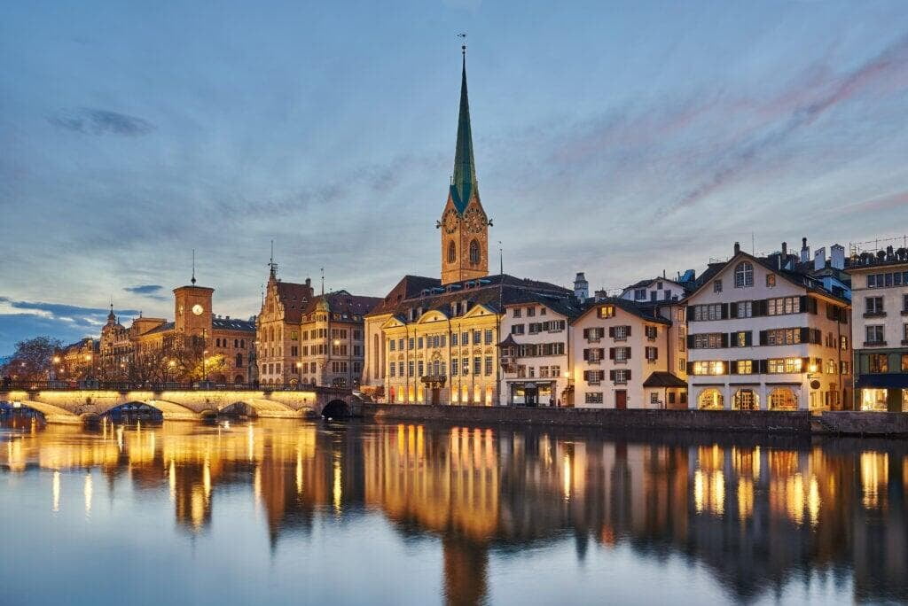  the Fraumünster Church in Zurich, Switzerland, with its tall spire set against a partly cloudy sky