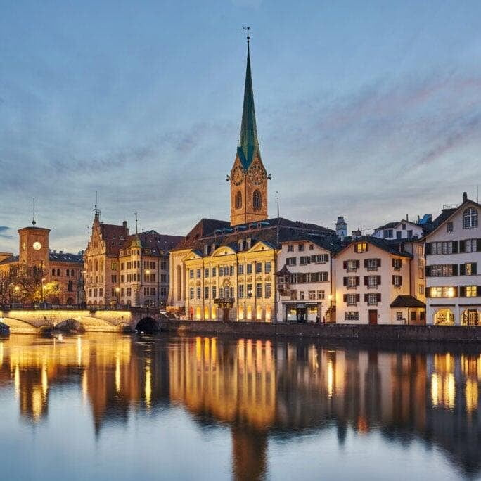  the Fraumünster Church in Zurich, Switzerland, with its tall spire set against a partly cloudy sky