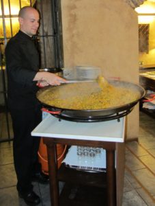 Chef preparing paella to serve 50 hungry travelers. 